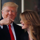 U.S. President Donald Trump reacts as he stands next to former White House Communications Director Hope Hicks.